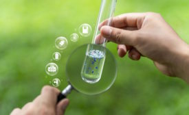 Image portraying someone examining microplastics in a test tube