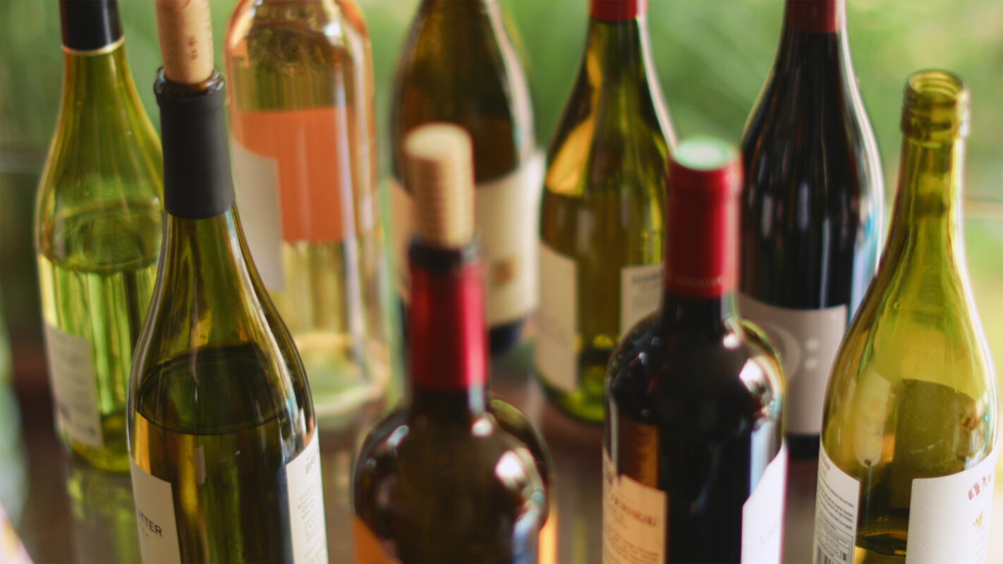 Variety of wine bottles on table.